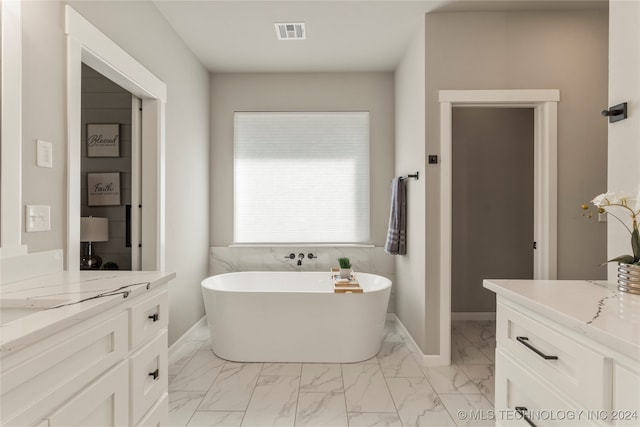 bathroom featuring vanity and a tub