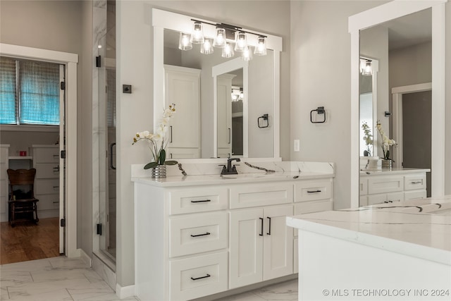 bathroom with vanity and a shower with shower door