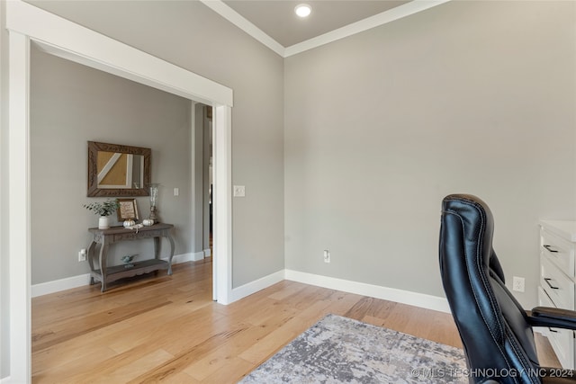 office area with crown molding and light wood-type flooring