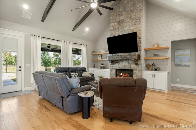 living room with ceiling fan, high vaulted ceiling, light hardwood / wood-style flooring, and a fireplace