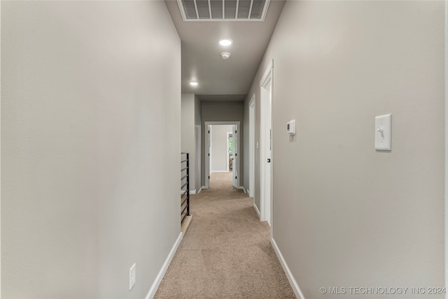 hallway featuring light carpet