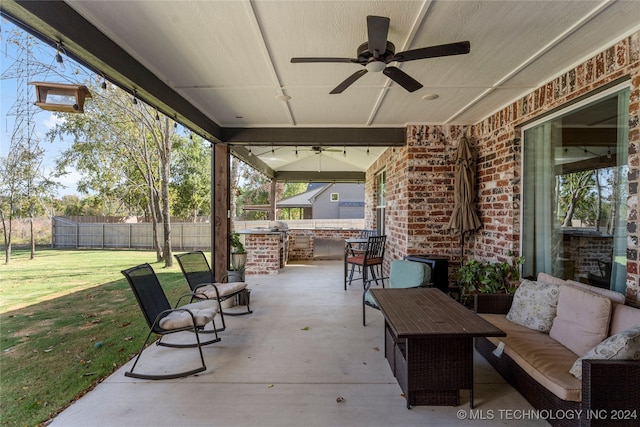 view of patio / terrace with exterior bar and ceiling fan