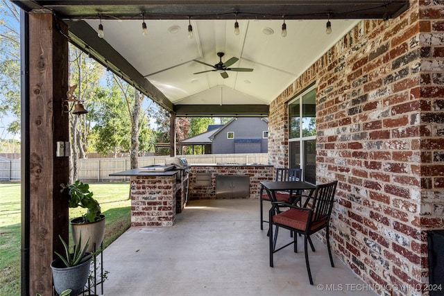 view of patio / terrace with exterior kitchen and ceiling fan