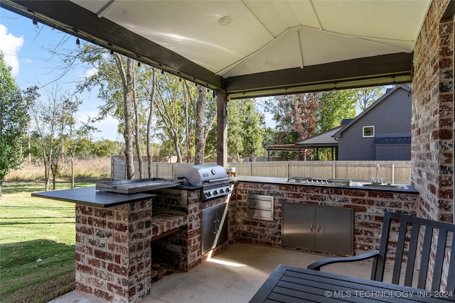 view of patio / terrace with a gazebo, a grill, and an outdoor kitchen