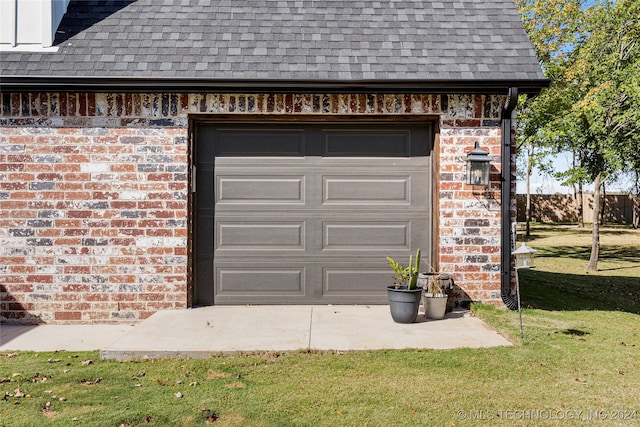 garage featuring a lawn