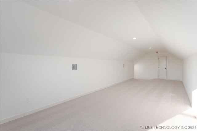 bonus room featuring lofted ceiling and carpet flooring