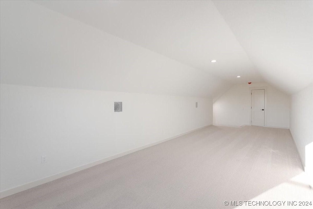 849 Springfield Ct, Durant, OK 74701 - additional living space with vaulted ceiling, light colored carpet, and recessed lighting
