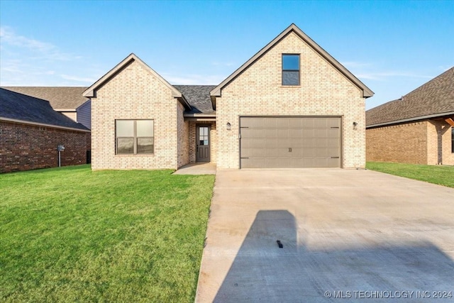 849 Springfield Ct, Durant, OK 74701 - view of front facade featuring brick siding, concrete driveway, a front yard, and a garage