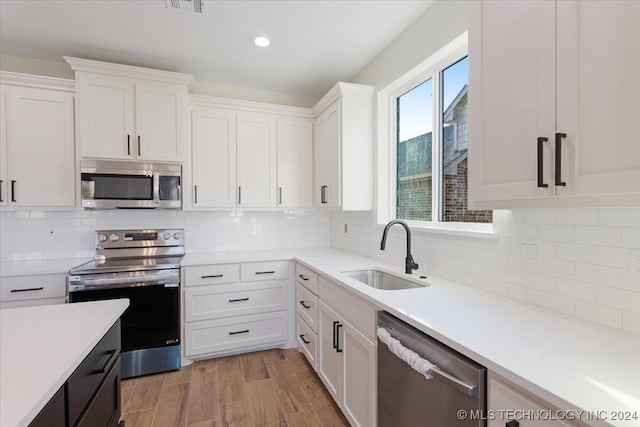 kitchen with white cabinets, stainless steel appliances, and sink