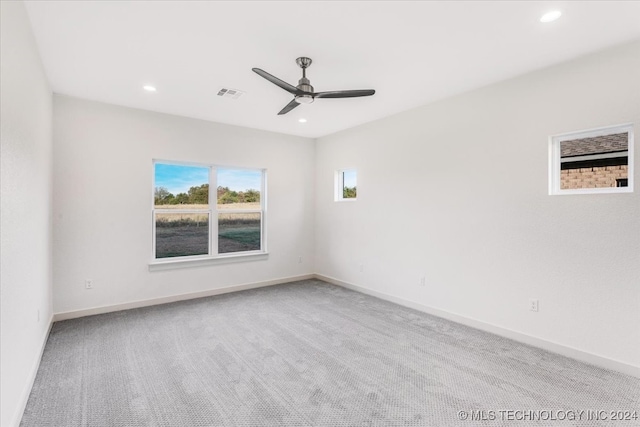 spare room featuring ceiling fan and carpet floors