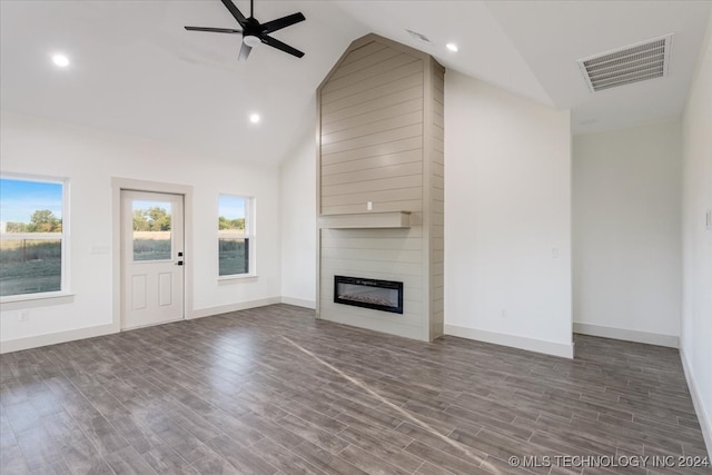 unfurnished living room featuring a large fireplace, high vaulted ceiling, dark hardwood / wood-style flooring, and ceiling fan