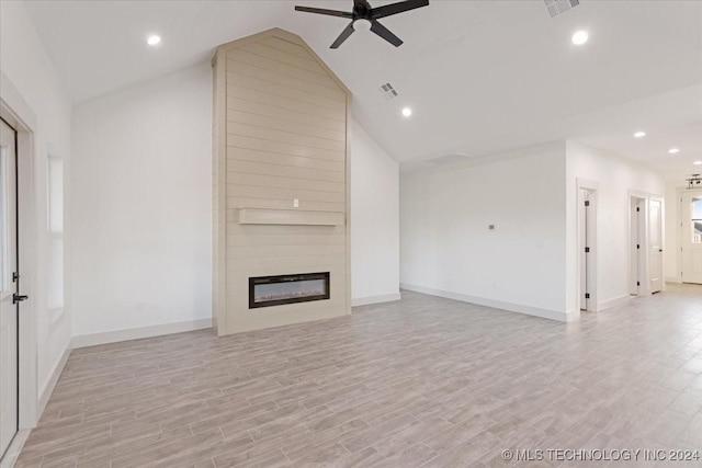 845 Springfield Ct, Durant, OK 74701 - unfurnished living room featuring ceiling fan, lofted ceiling, baseboards, a large fireplace, and light wood-style floors