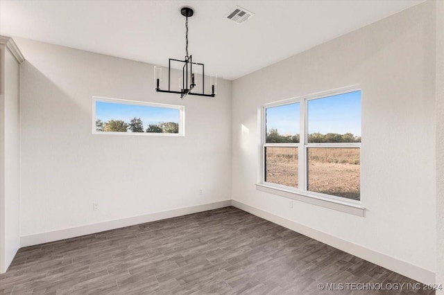 845 Springfield Ct, Durant, OK 74701 - empty room with a chandelier, wood finished floors, and baseboards