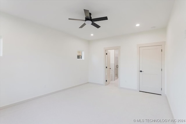 spare room with light carpet and ceiling fan