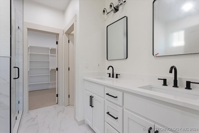 bathroom with vanity and a shower with shower door