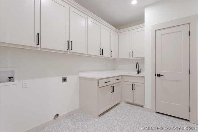 845 Springfield Ct, Durant, OK 74701 - laundry room with cabinet space, electric dryer hookup, hookup for a washing machine, and baseboards