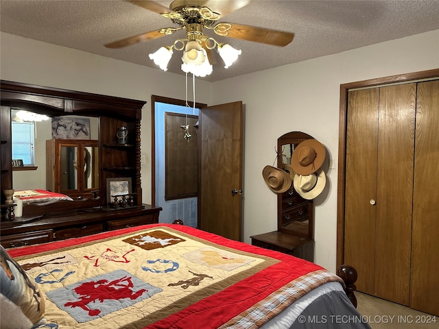 carpeted bedroom with a textured ceiling and ceiling fan