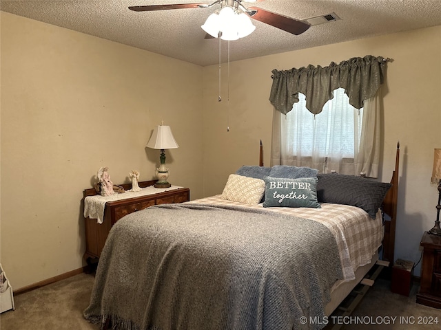 carpeted bedroom with a textured ceiling and ceiling fan