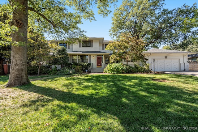 view of front of home with a front lawn and a garage