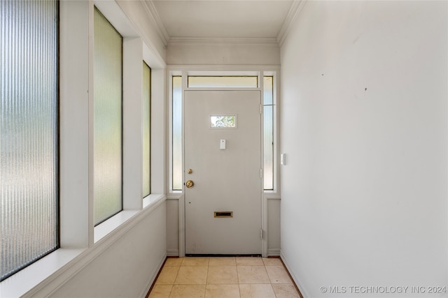 doorway with ornamental molding and light tile patterned flooring