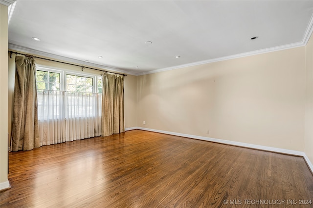 spare room with ornamental molding and wood-type flooring