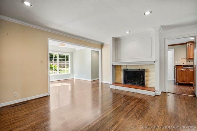 unfurnished living room featuring wood-type flooring and ornamental molding