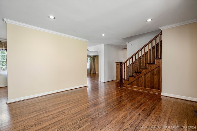 unfurnished room with dark wood-type flooring and crown molding