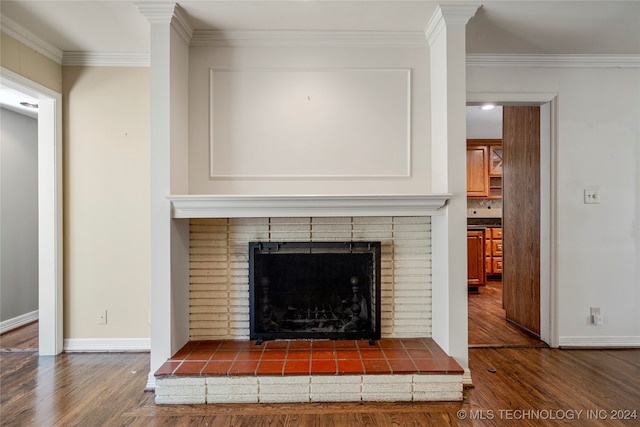 interior details with ornamental molding, wood-type flooring, and a brick fireplace