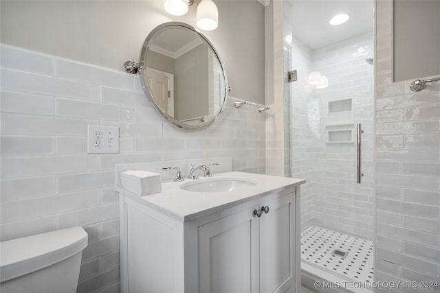 bathroom with vanity, toilet, tile walls, and tiled shower