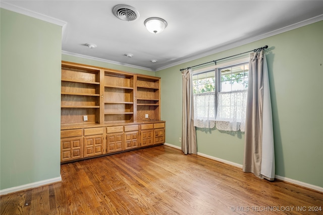 interior space featuring crown molding and wood-type flooring