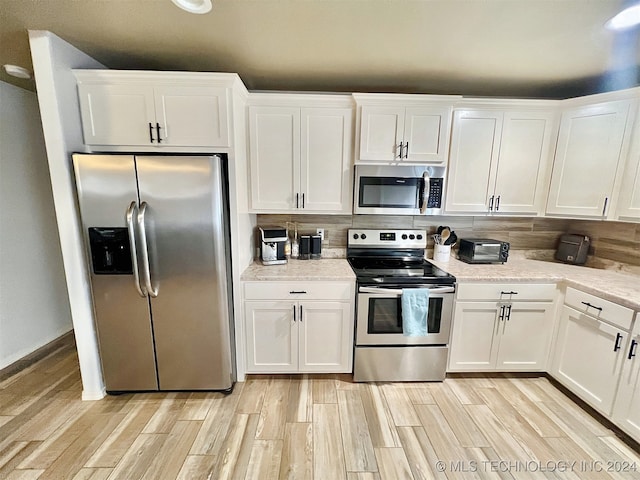 kitchen featuring white cabinetry, appliances with stainless steel finishes, and light wood-type flooring