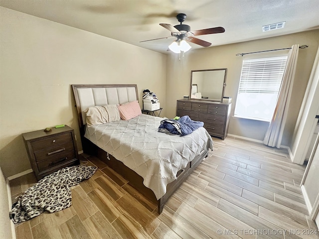 bedroom with light wood-type flooring and ceiling fan