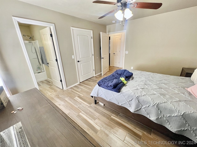 bedroom with ensuite bath, light hardwood / wood-style flooring, and ceiling fan