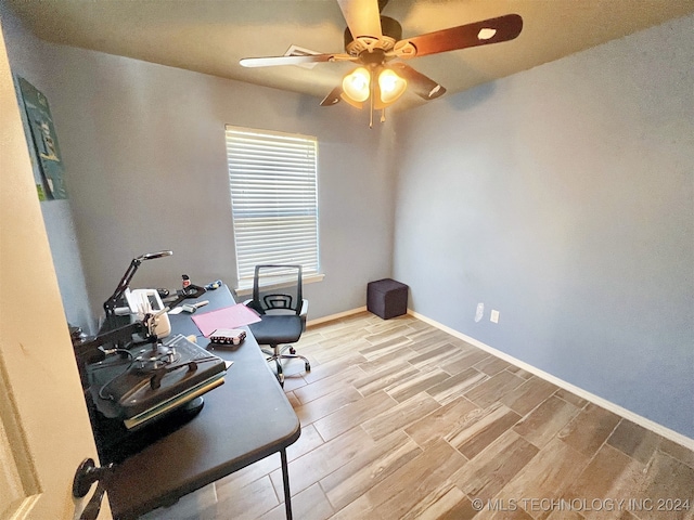 office area with light wood-type flooring and ceiling fan