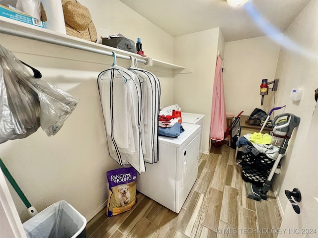 laundry room featuring light hardwood / wood-style flooring and separate washer and dryer