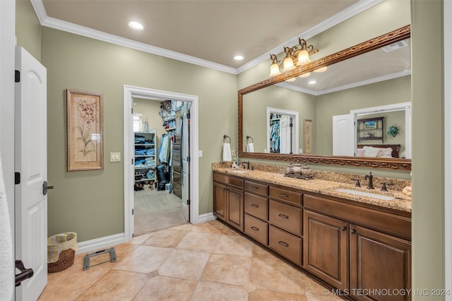 bathroom with vanity, ornamental molding, and tile patterned flooring