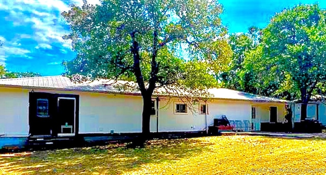 back of house with a lawn