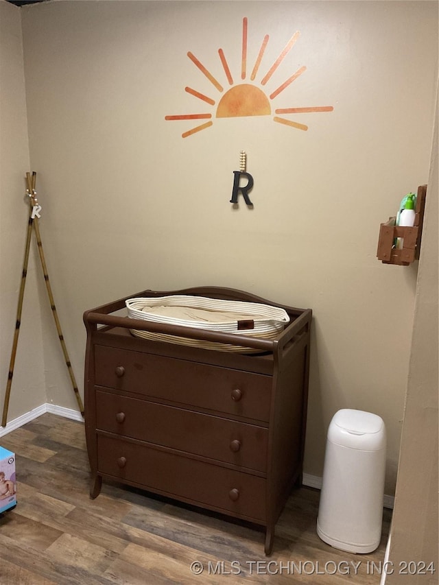 bedroom with baseboards and wood finished floors