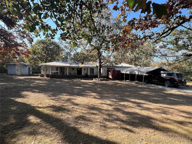 ranch-style house featuring a carport