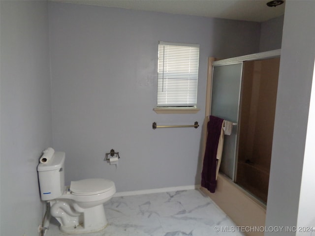 bathroom with toilet and enclosed tub / shower combo