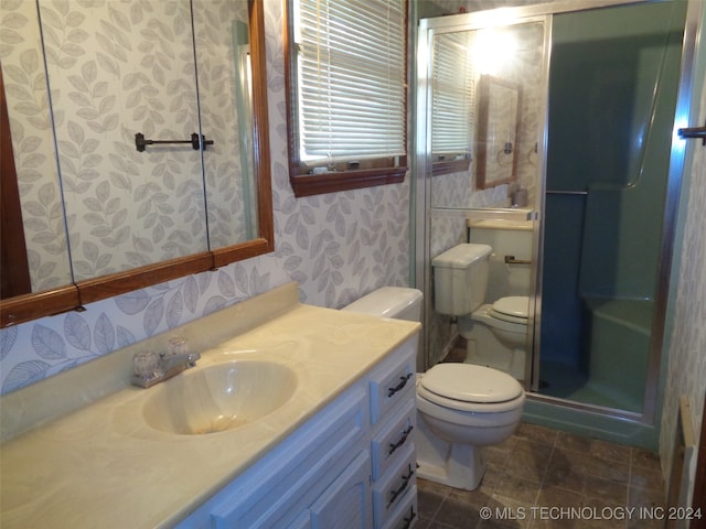 bathroom featuring toilet, an enclosed shower, and vanity