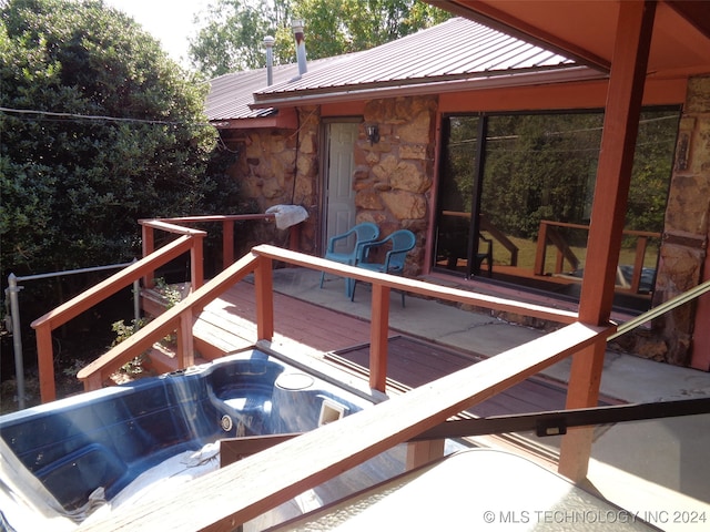 wooden terrace with an outdoor hot tub