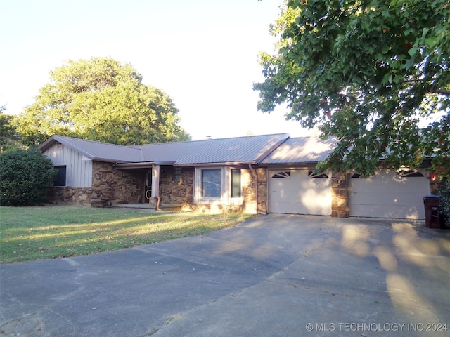 ranch-style house with a front yard and a garage