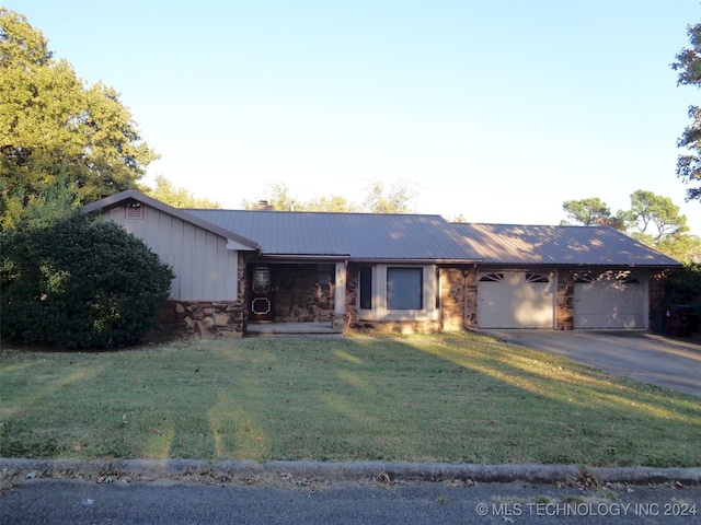 ranch-style house with a front yard and a garage