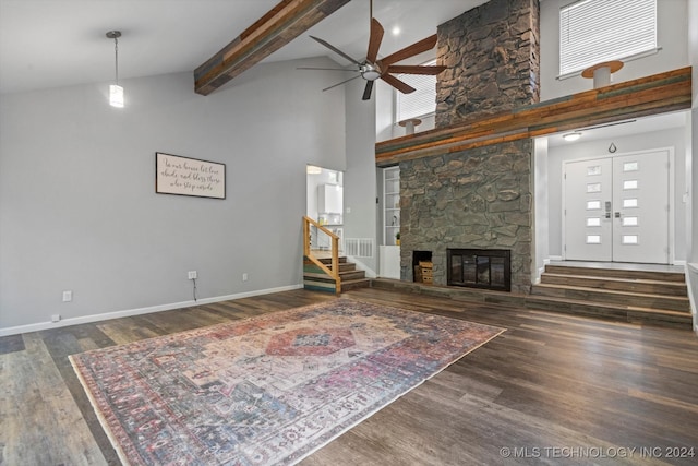 living room featuring ceiling fan, dark hardwood / wood-style flooring, a fireplace, and high vaulted ceiling