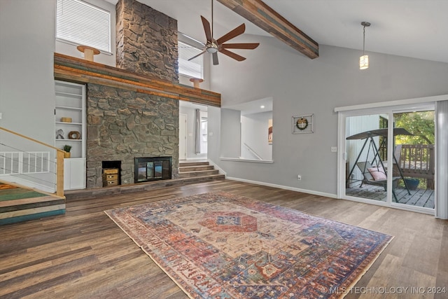 living room featuring ceiling fan, hardwood / wood-style flooring, high vaulted ceiling, beamed ceiling, and a fireplace