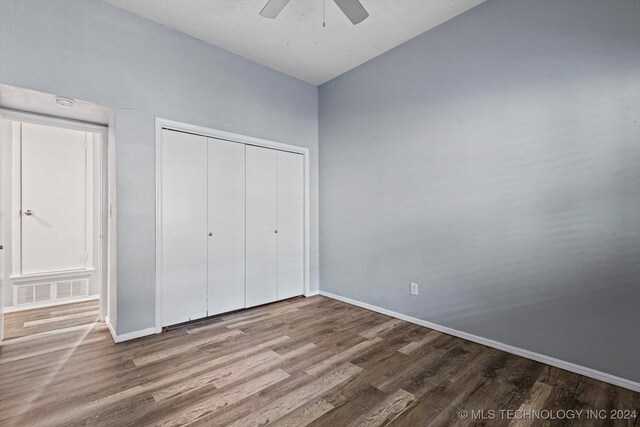 unfurnished bedroom with a closet, ceiling fan, and hardwood / wood-style floors