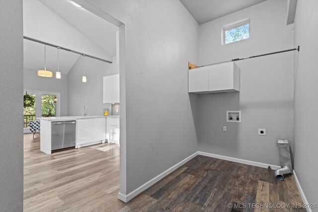 laundry area featuring washer hookup, electric dryer hookup, sink, hardwood / wood-style flooring, and a high ceiling