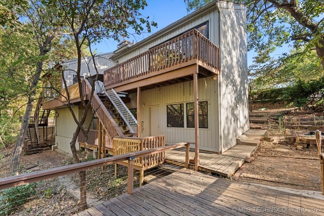 rear view of house featuring a deck