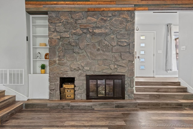 room details featuring a fireplace, hardwood / wood-style flooring, and built in features